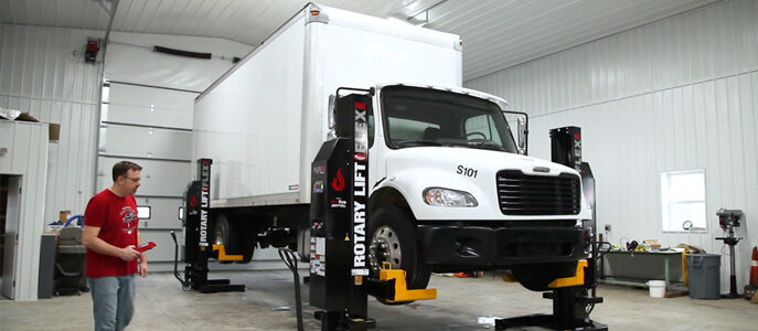 Mobile Rotary Lift suspending a large white box truck