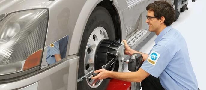 A technician performing a wheel alignment