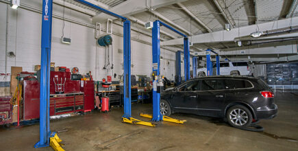 Vehicle by automotive lifts in a repair shop