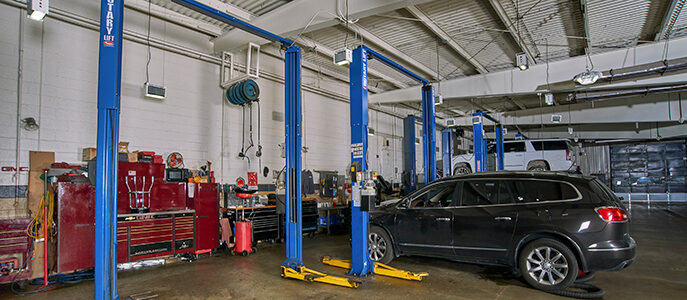 Vehicle by automotive lifts in a repair shop