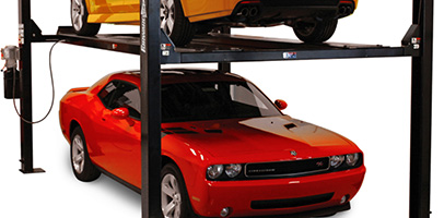 Red car parked below a yellow car elevated on a Forward EFP9